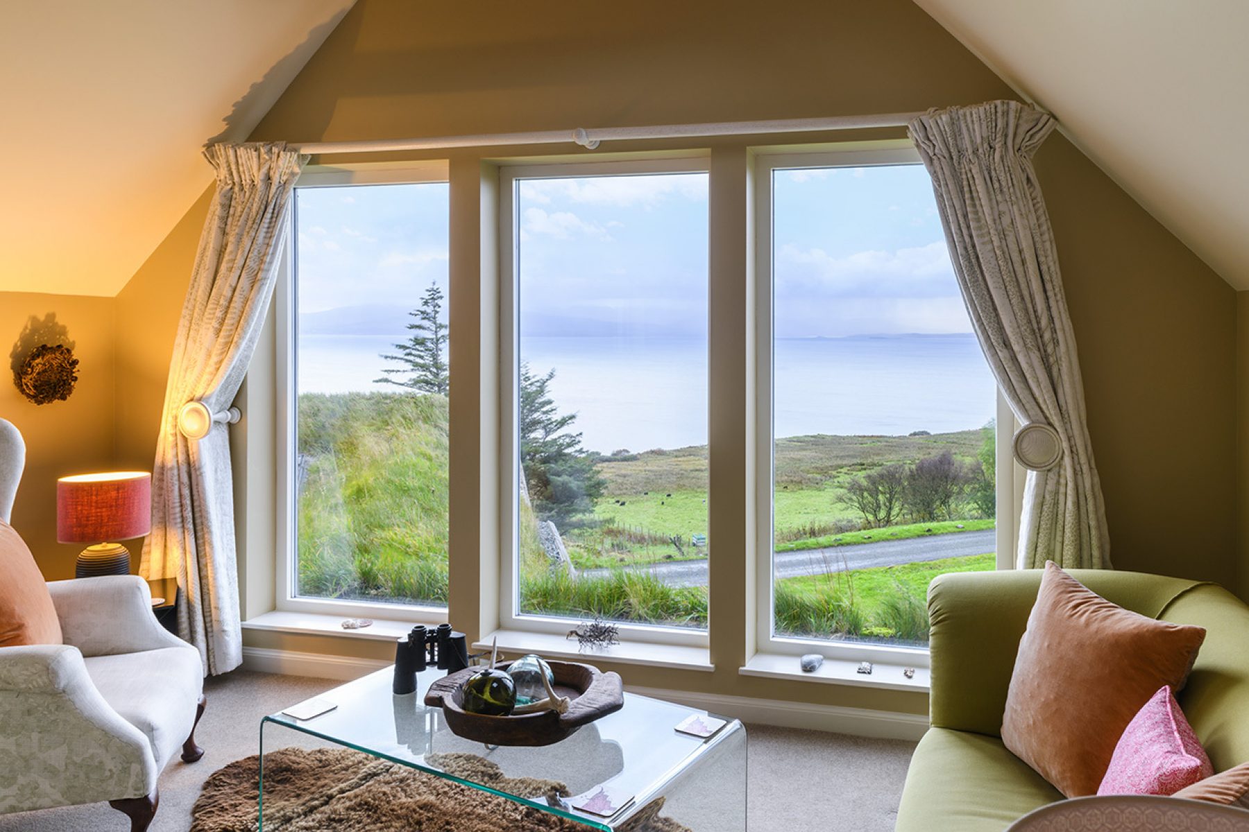 Upstairs in the Blackhouse cottage. Floor to ceiling windows frame stunning views over Loch Snizort.