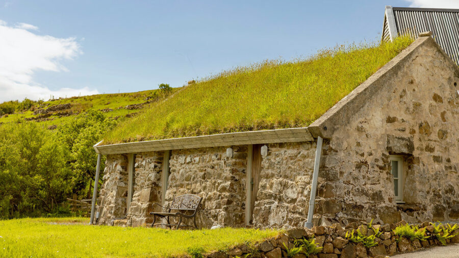 The stone blackhouse with a turf roof, vernacular Hebridean architecture, restored at Mint Croft, Skye, Scotland.
